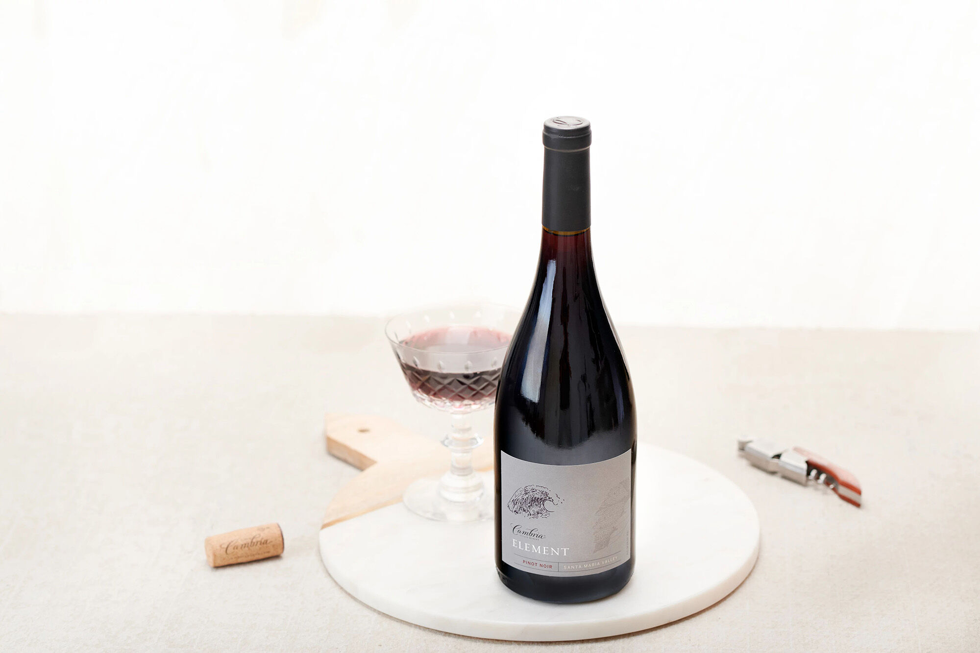 A bottle of red wine with a grey label.
